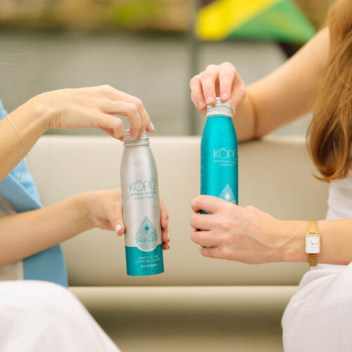 KOPU sparkling water aluminum cans being opened.