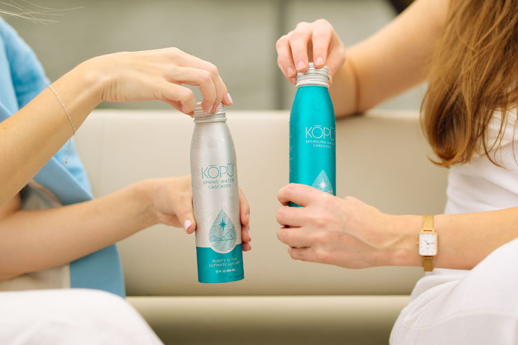 KOPU sparkling water aluminum cans being opened.