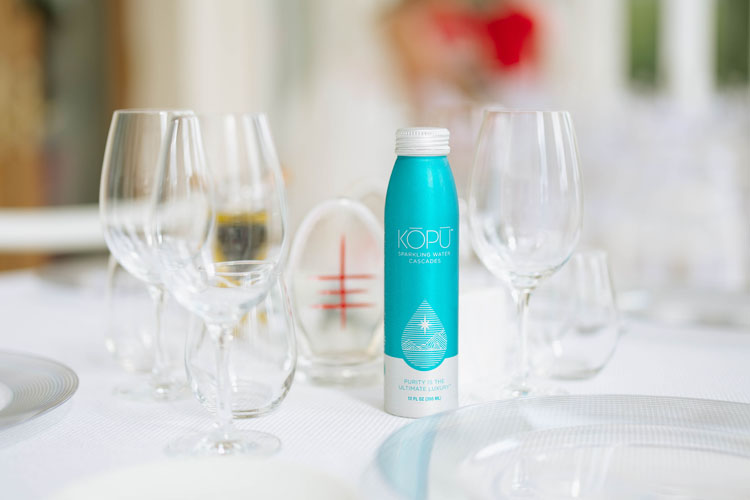 KOPU Sparkling water aluminum can on table.